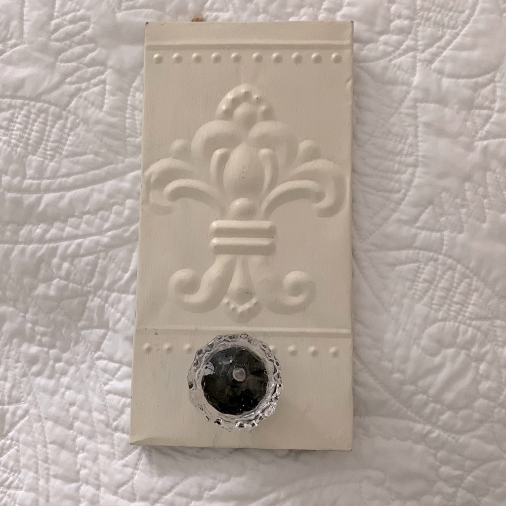 Cream decorative hook with fleur de lis design